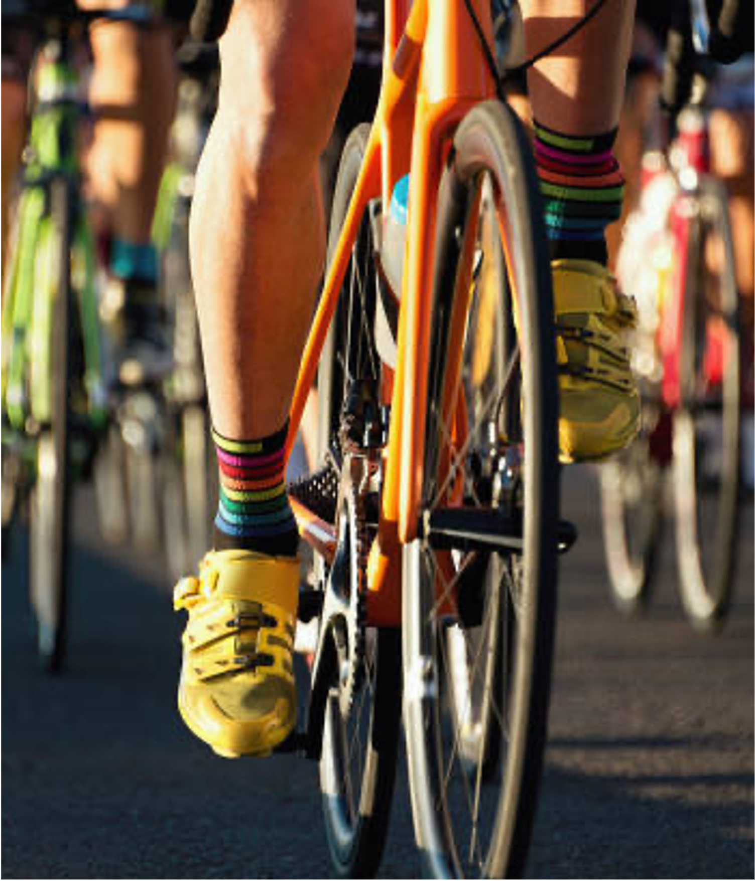 dev-squad2 A small group of cyclists standing at the side of the road with a sunrise in the background