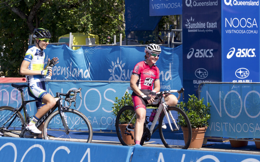 Cyclists finishing the Noosa criterium in hot summer conditions, showing real-world hydration and salt-loss demands during racing.