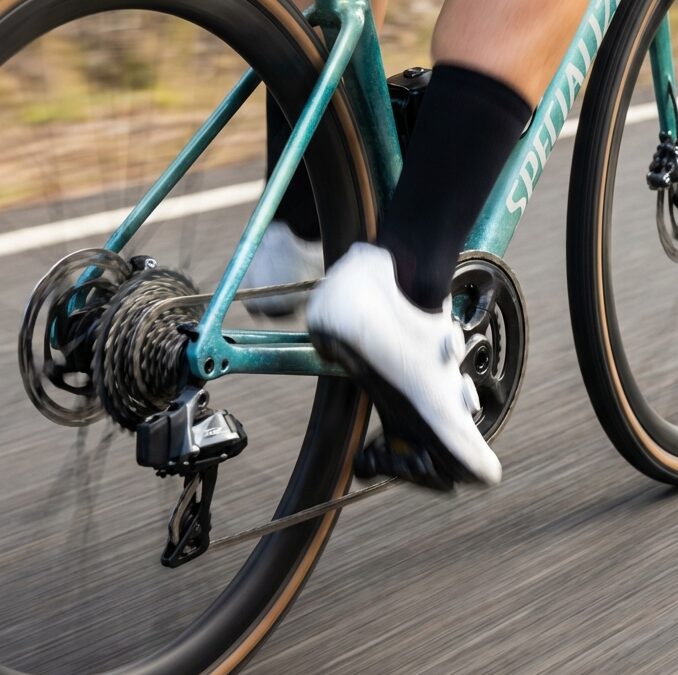 Close-up of a cyclist pedalling a road bike showing smooth cycling cadence