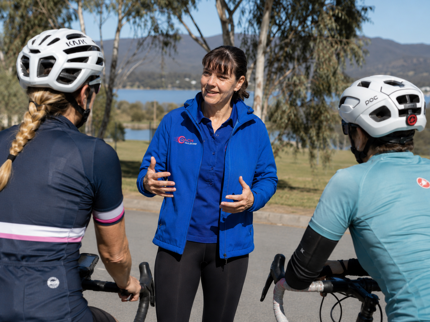 Coach Hulskamp discussing training priorities with a group of cyclists