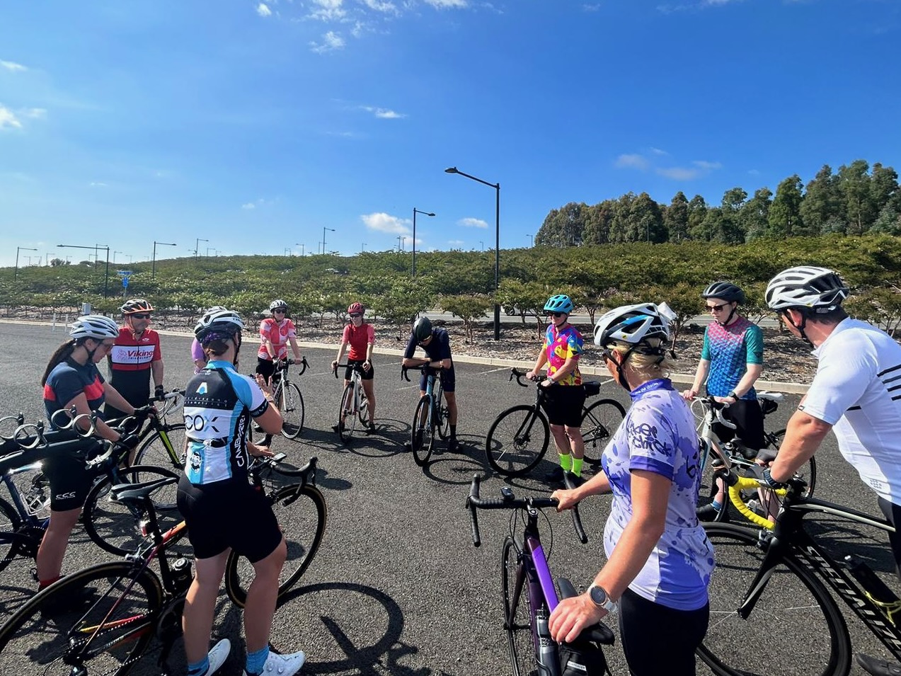 Group of adult cyclists participating in a Coach Hulskamp cycling skills session in Canberra